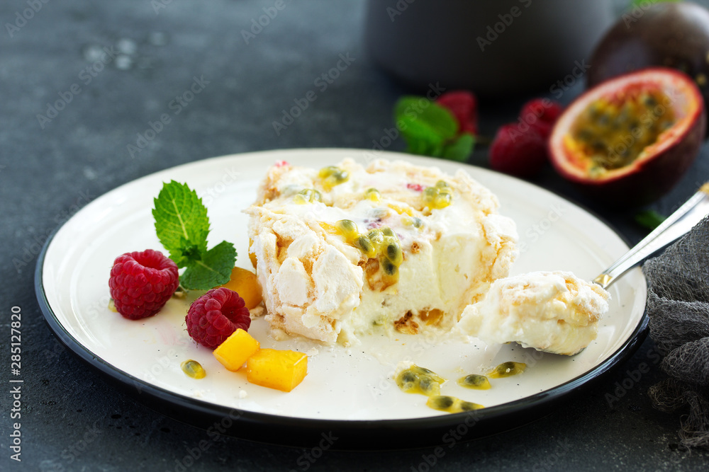 Meringue roulade with raspberries and passion fruit. Pavlova. Dessert. Selective focus Meringue roulade with raspberries and passion fruit. Pavlova. Dessert. Selective focus