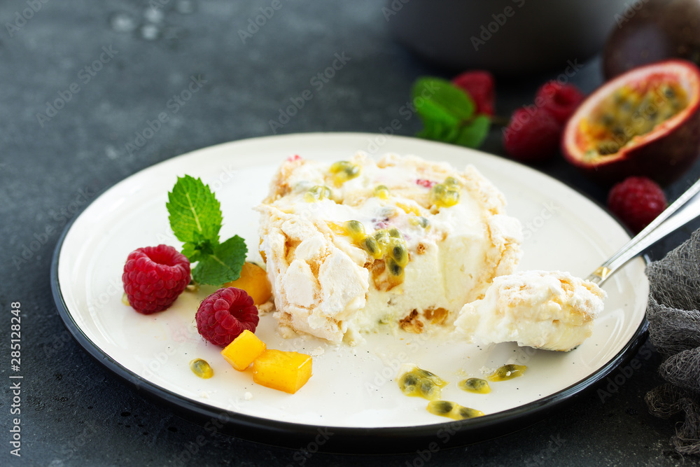 Meringue roulade with raspberries and passion fruit. Pavlova. Dessert. Selective focus Meringue roulade with raspberries and passion fruit. Pavlova. Dessert. Selective focus