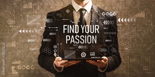 Find your passion with businessman holding a tablet computer on a dark vintage background photo