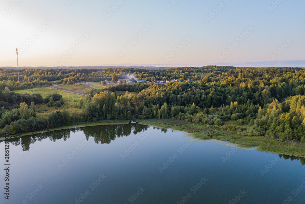 aerial view of landscape with lake at sunset aerial view of landscape with lake at sunset