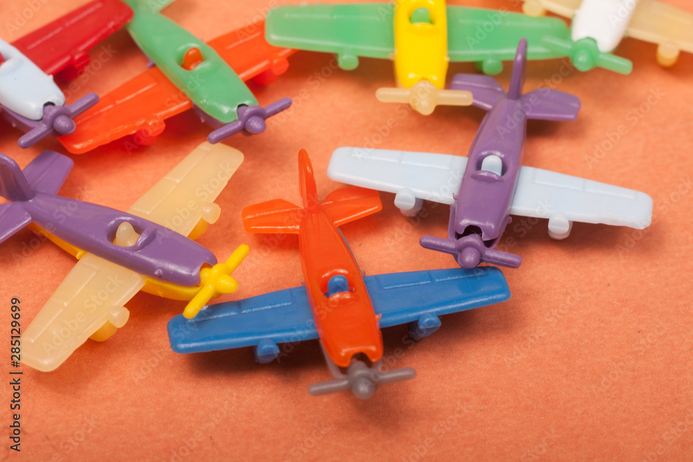 Fototapeta premium toys plastic aeroplanes on a orange background