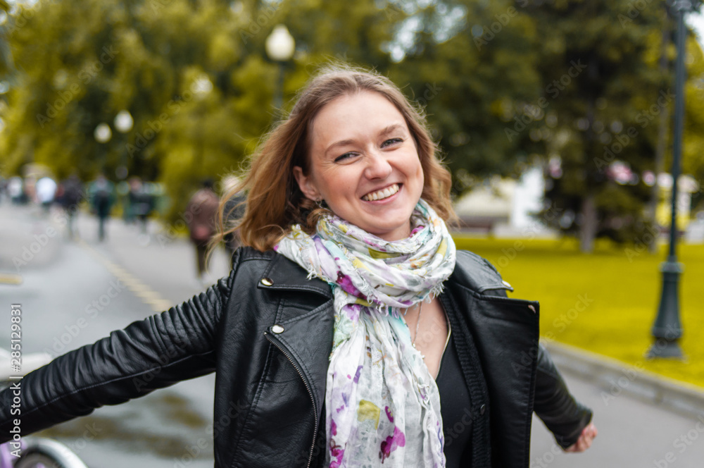 Happy woman with open arms outdoors enjoying her freedom outdoors in the Park Happy woman with open arms outdoors enjoying her freedom outdoors in the Park
