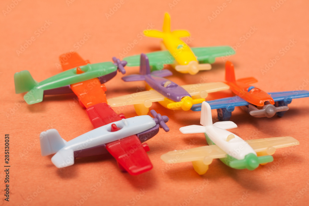 Naklejka premium toys plastic aeroplanes on a orange background