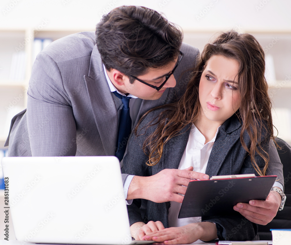 Sexual harassment concept with man and woman in office Sexual harassment concept with man and woman in office