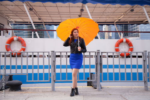 redheaded women under the orange heart shaped umbrella