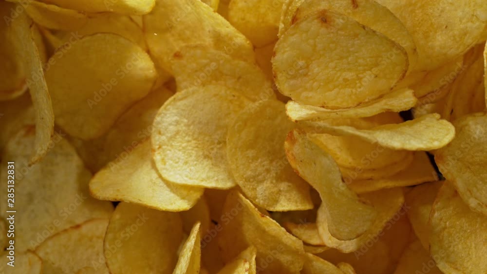 Super Slow Motion Shot of Potato Chips Flies After Being Exploded against Black Background, 1000fps. Shooted with High Speed Cinema Camera at 4K. Super Slow Motion Shot of Potato Chips Flies After Being Exploded against Black Background, 1000fps. Shooted with High Speed Cinema Camera at 4K.