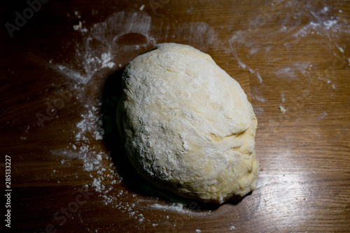 Knead the dough on a wooden table