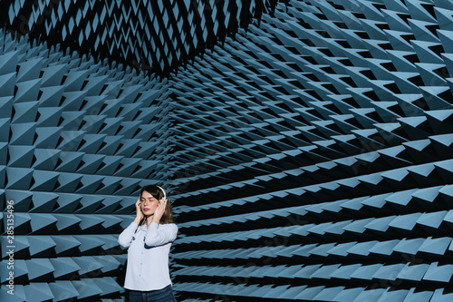 Woman in sound room listening to music