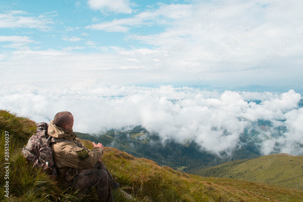 A man sits on top of a mountain A man sits on top of a mountain