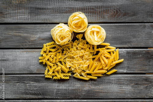 Italian pasta for restaurant on wooden table background top view