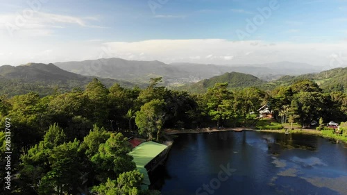 Lake on high hill in sunny bright day aerial drone view photo