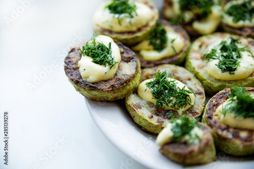 homemade zucchini fried with mayonnaise. On a white background
