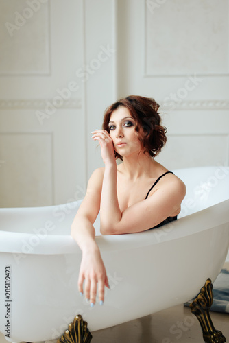 beautiful girl in the bathtub water in underwear
