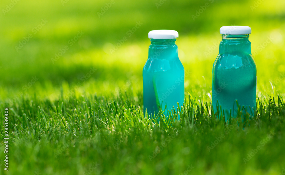 Blue fresh water of natural components in grass with sun lights Blue fresh water of natural components in grass with sun lights