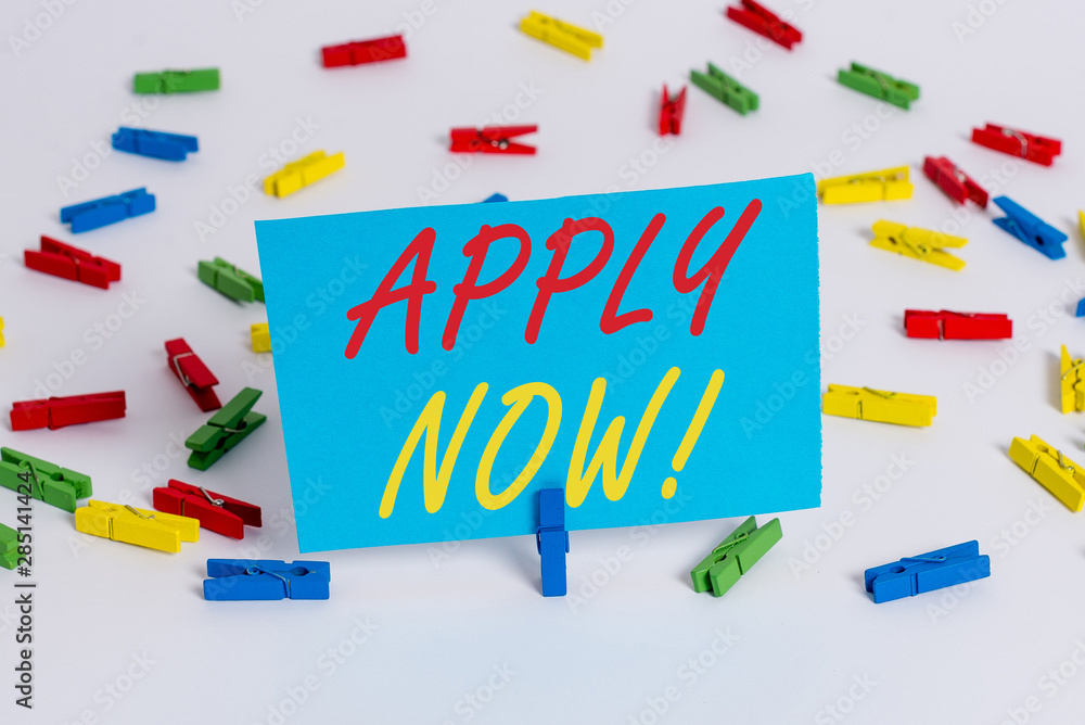 Text sign showing Apply Now. Business photo text request something officially in writing or by sending in form Colored clothespin papers empty reminder white floor background office Text sign showing Apply Now. Business photo text request something officially in writing or by sending in form Colored clothespin papers empty reminder white floor background office