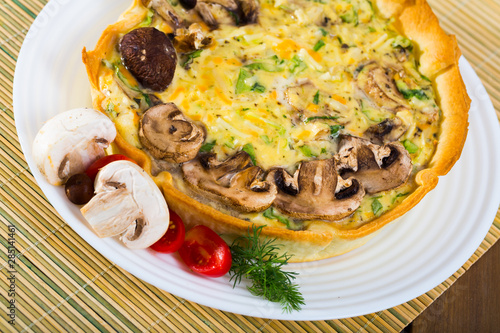 Delicious french  open pie with cheese and mushrooms