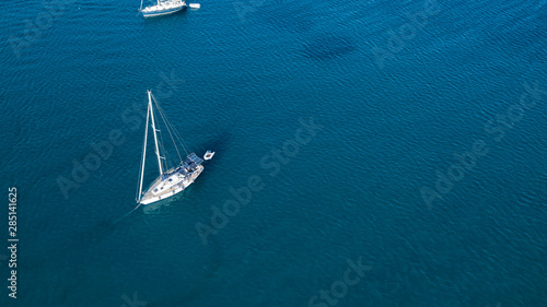 Aerial shot of a sailboat at blue color sea © ucarer