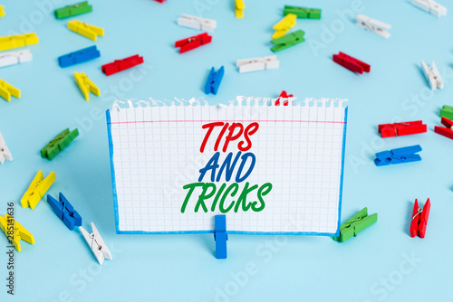 Text sign showing Tips And Tricks. Business photo showcasing piece of inside facts specially in betting or investing Colored clothespin papers empty reminder blue floor background office pin