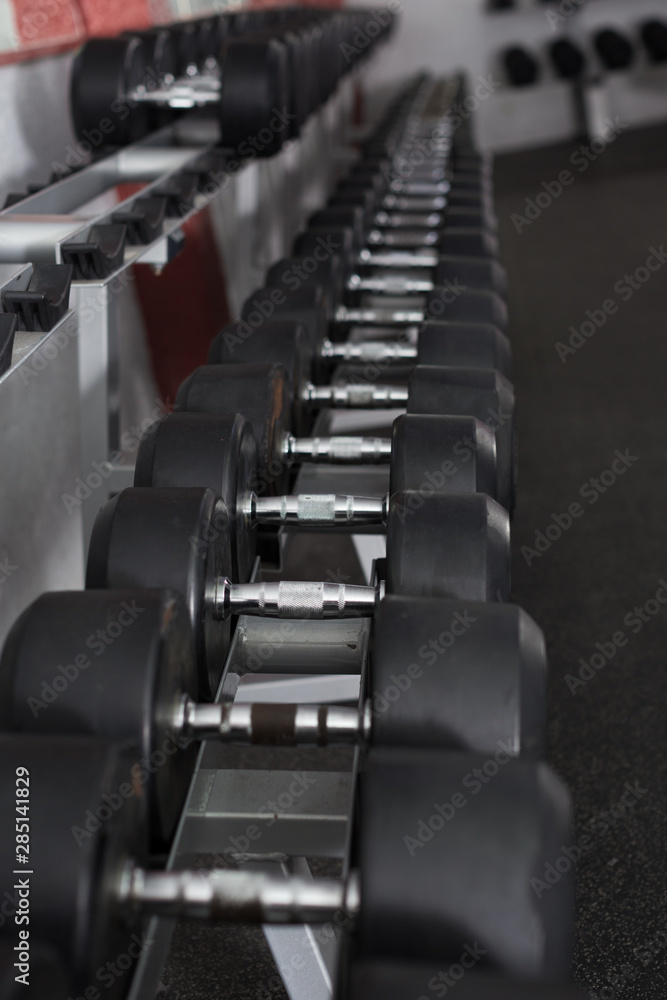Obraz premium Rows of dumbbells in gym