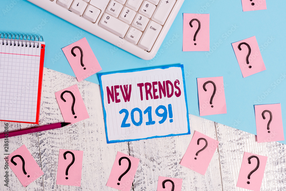 Writing note showing New Trends 2019. Business concept for general direction in which something is developing Writing tools and scribbled paper on top of the wooden table Writing note showing New Trends 2019. Business concept for general direction in which something is developing Writing tools and scribbled paper on top of the wooden table