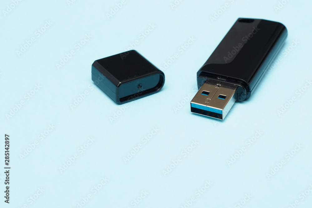 isolate flash drive on a blue background. electronics concept. memory for transferring files and information. small flash card. isolate flash drive on a blue background. electronics concept. memory for transferring files and information. small flash card.