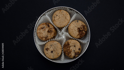 Cookie in a round box closeup. Traditional chocolate chip cookies.