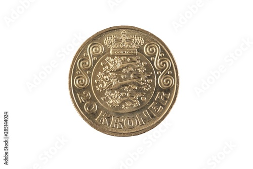 A gold, twenty Danish krone coin cut out on a clean, white background in isolation.  Shot in close up macro.