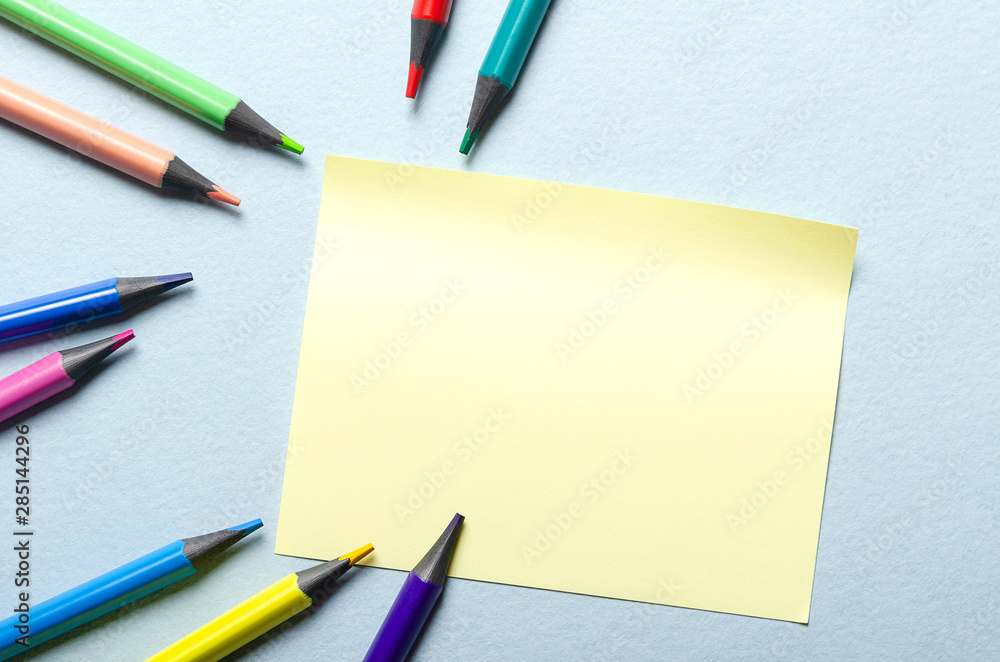 Sticky note paper on the desktop with colored pencils. Sticky note paper on the desktop with colored pencils.