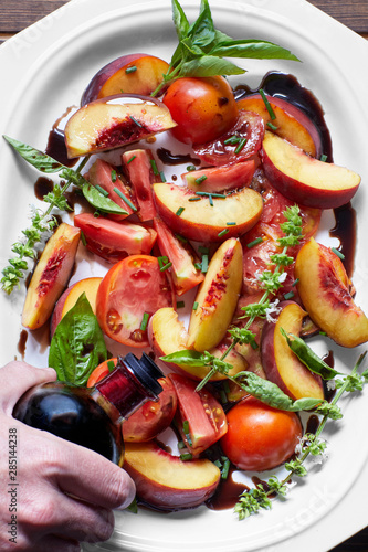 Close up of man's hand preparing salad