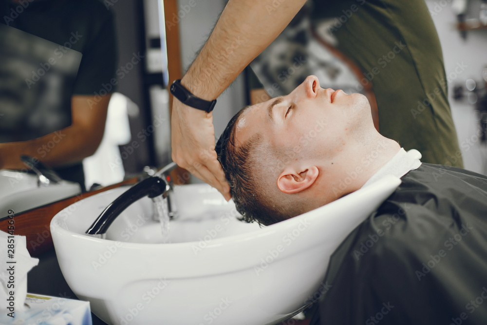 A man in a barbershop. Wash your head in the barber. Rest in hairdressing salon. A man in a barbershop. Wash your head in the barber. Rest in hairdressing salon.
