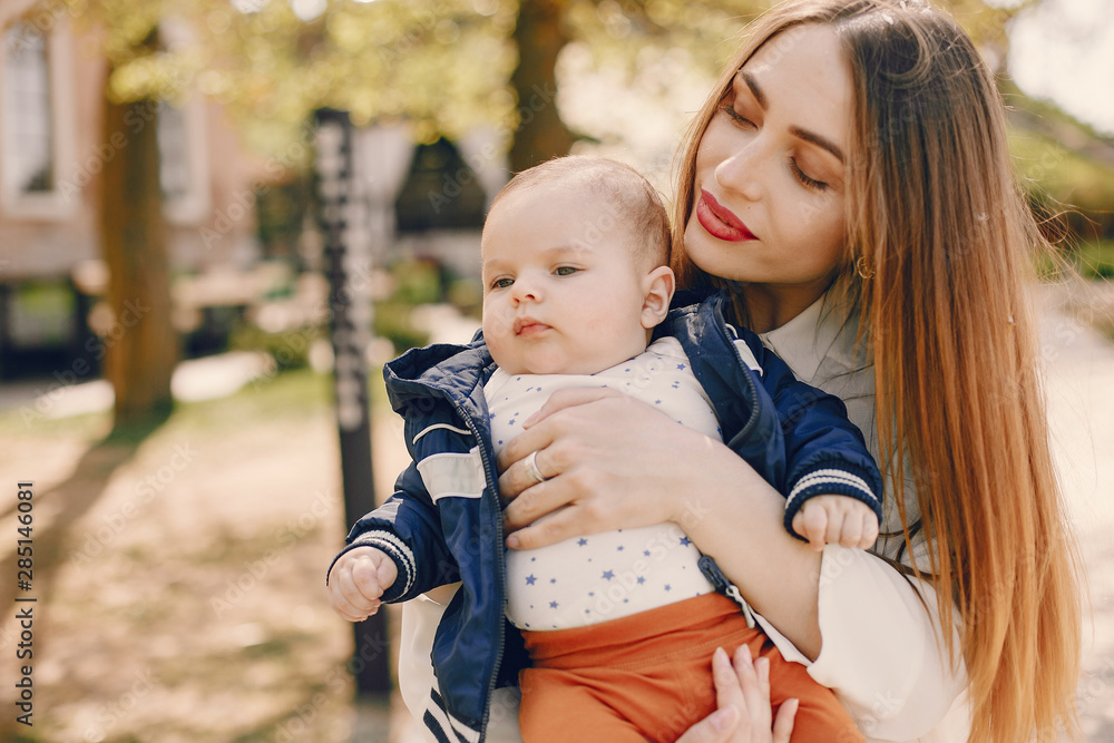 Obraz premium Family in a summer park. Mother in a white shirt. Cute little boy