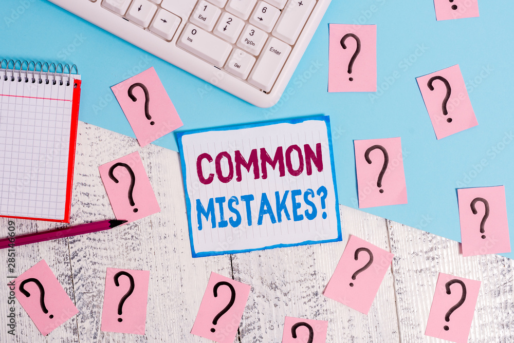 Writing note showing Common Mistakes Question. Business concept for repeat act or judgement misguided making something wrong Writing tools and scribbled paper on top of the wooden table Writing note showing Common Mistakes Question. Business concept for repeat act or judgement misguided making something wrong Writing tools and scribbled paper on top of the wooden table