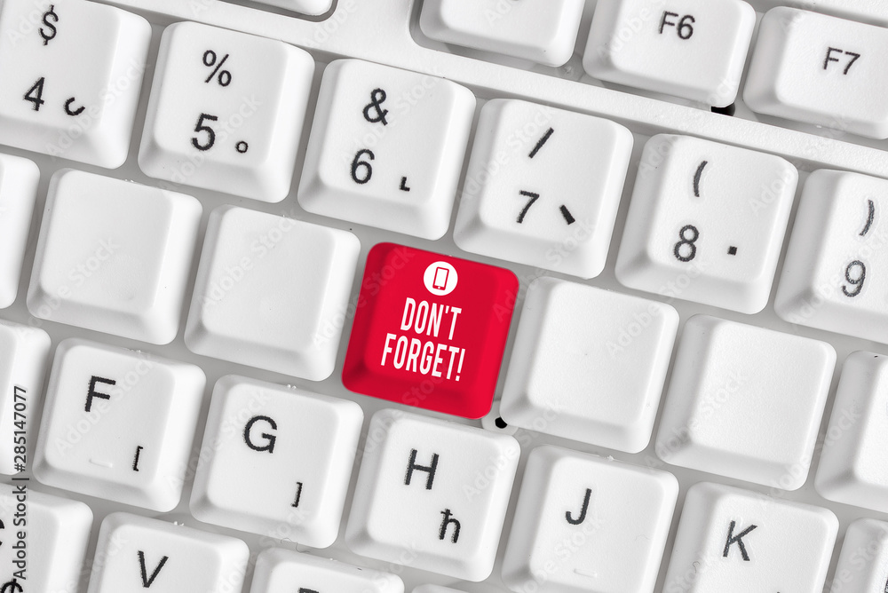Conceptual hand writing showing Don T Forget. Concept meaning used to remind someone about an important fact or detail White pc keyboard with note paper above the white background