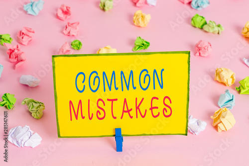 Word writing text Common Mistakes. Business photo showcasing actions that are often used interchangeably with error Colored crumpled papers empty reminder pink floor background clothespin © Artur