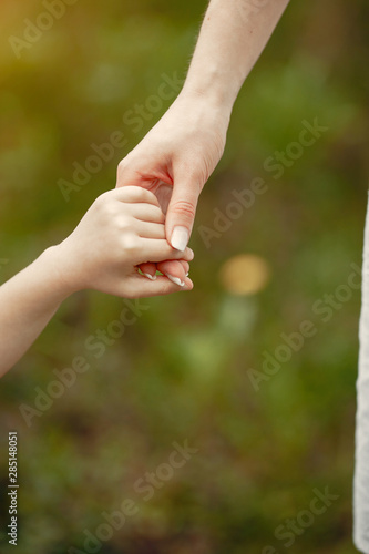 Pretty mother with daughter. Family in a spring park. Woman in a white dress © hetmanstock2