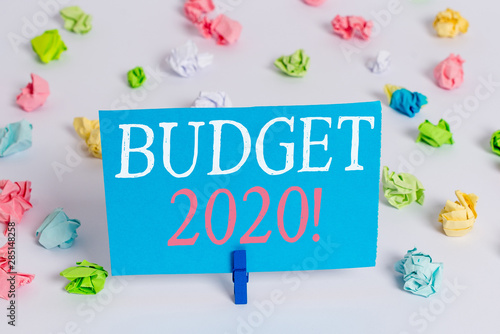 Writing note showing Budget 2020. Business concept for estimate of income and expenditure for next or current year Colored crumpled paper empty reminder white floor clothespin © Artur