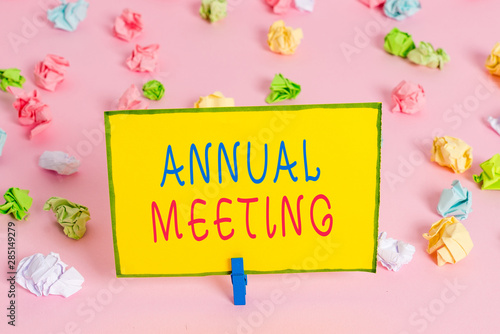 Word writing text Annual Meeting. Business photo showcasing yearly meeting of the general membership of an organization Colored crumpled papers empty reminder pink floor background clothespin photo