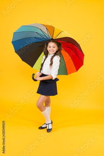 Fancy schoolgirl. Girl with umbrella. Rainy day. Happy childhood. Kid happy with umbrella. Fall weather forecast. On way to school. Fashion accessory. Rainy september. Accessory for rainy day