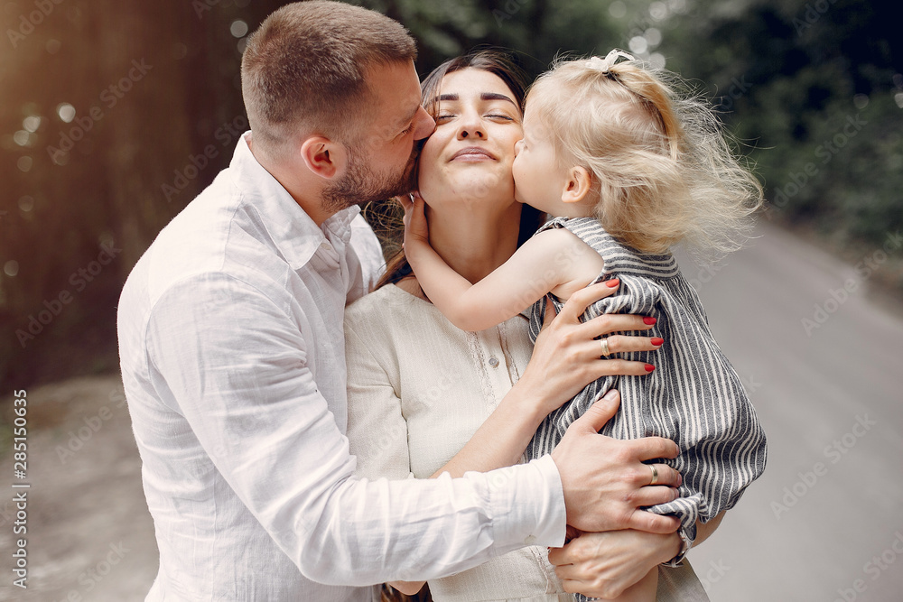 Fototapeta premium Family in a summer park. Mother and little daughter playing. Cute little girl with a father