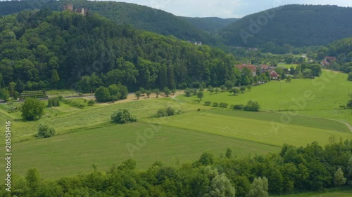 Aerial view of the  village and castle Gamburg in Germany. Pan to the right with wide view of the castle on top of the hill. photo