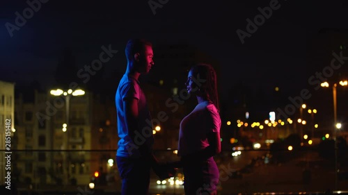 Young couple meeting in night city, falling in love at first sight, fate concept
