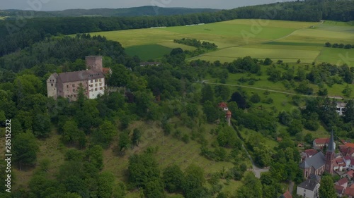 Aerial view of the  village and castle Gamburg in Germany. Pan to the right and zoom out revealing the village beside the castle. photo