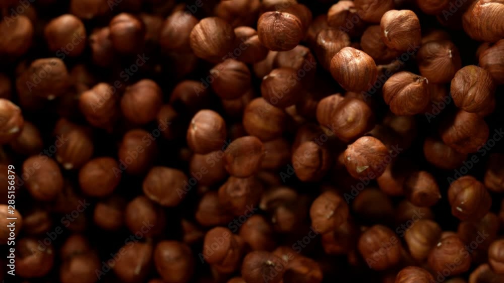 Super slow motion of flying hazelnuts on black background. Filmed on high speed cinema camera, 1000 fps. Super slow motion of flying hazelnuts on black background. Filmed on high speed cinema camera, 1000 fps.