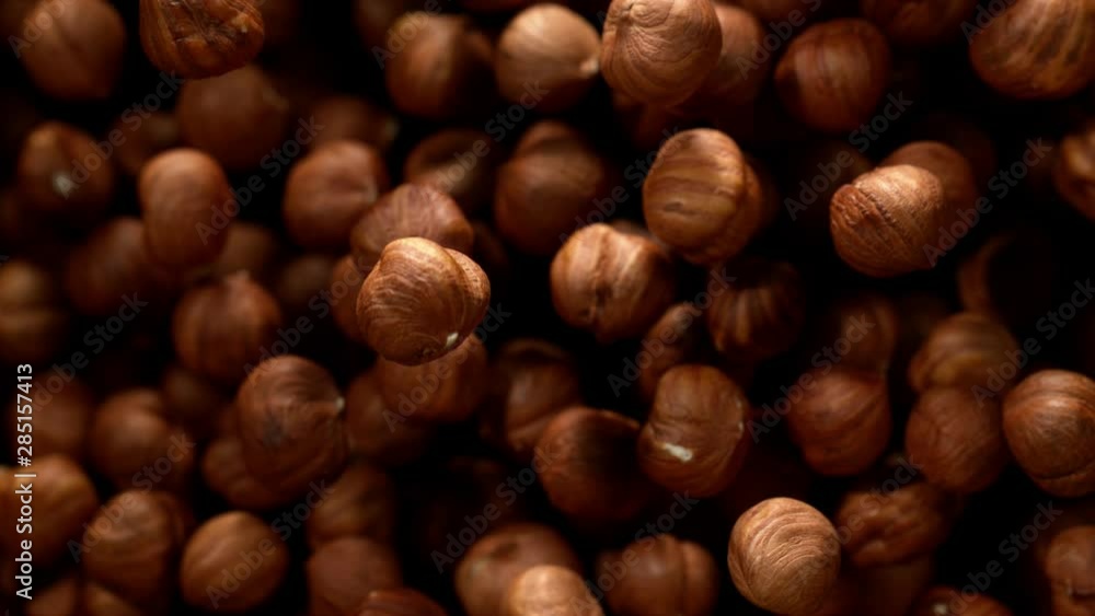 Super slow motion of flying hazelnuts on black background. Filmed on high speed cinema camera, 1000 fps. Super slow motion of flying hazelnuts on black background. Filmed on high speed cinema camera, 1000 fps.