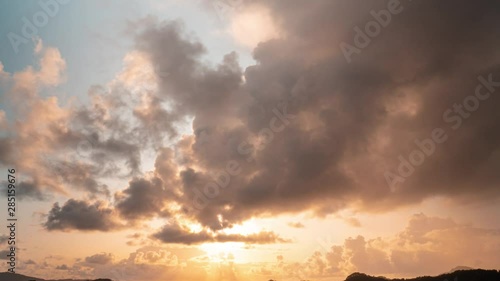 Timelapse of a calmful sunset with dark clouds moving towards camera - 4K photo