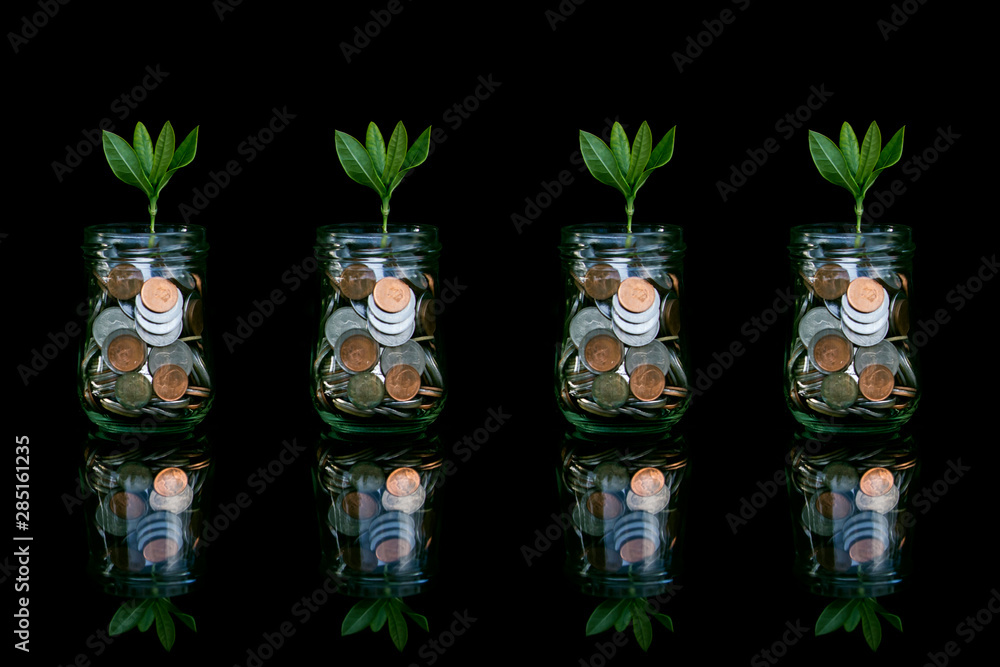 Coins in glass jar set on wooden plates, Coins in glass jar set on wooden plates,