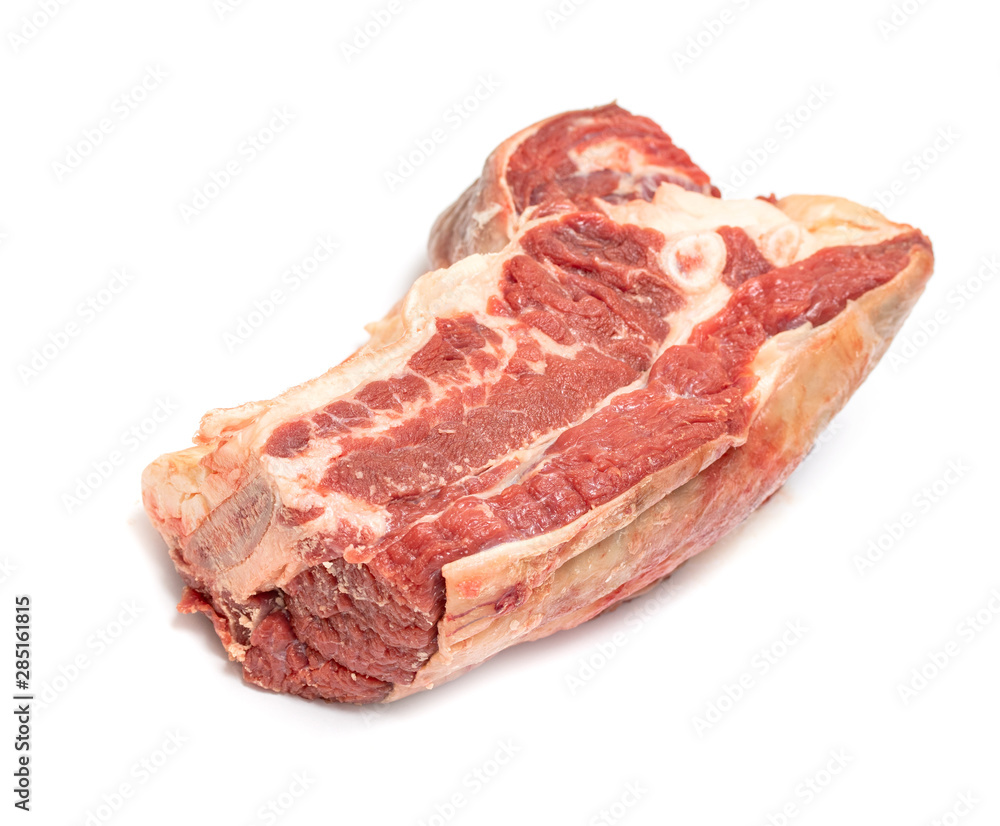A piece of raw beef meat on a white background isolated. A piece of raw beef meat on a white background isolated.