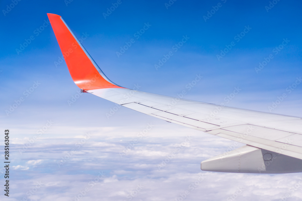 Air plane flying over the cloudy sky background. Concept of transportation, traveler and tourism.