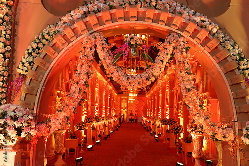 Luxurious indian wedding decoration entrance decorated with lighting and flowers, selective focus - Image
