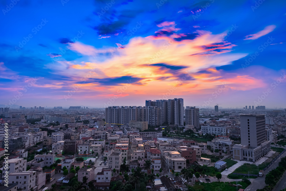 residential area in a chinese suburb in the evening with beautiful gold clouds and blue sky